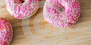 Sugar addiction: Close up of sugar sprinkled pink donut