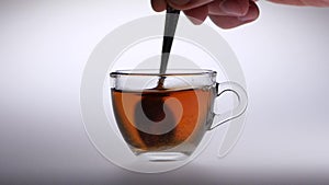 Sugar stir in a cup with tea of a spoon