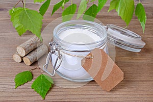 Sugar substitute xylitol, a glass jar with birch sugar and a label for text in your language photo