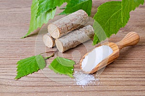 Sugar substitute xylitol, scoop with birch sugar, liefs and wood