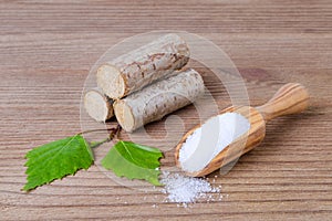 Sugar substitute xylitol, scoop with birch sugar, liefs and wood