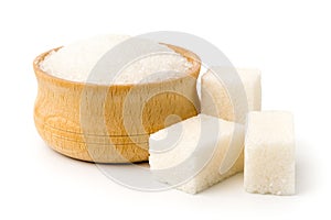 Sugar in wooden plate and cubes refined on white background.