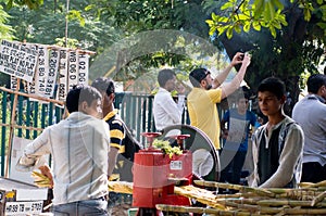 Sugarcane juice vendor extracting juice