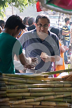 Sugarcane juice vendor serving a customer in India