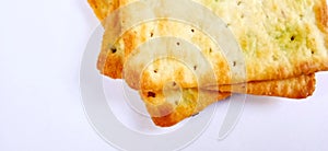 Sugarless and vegetable healthy cracker biscuit slices on the gray white studio background. Food background design.