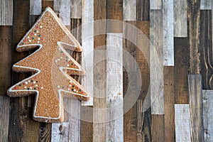 Sugary gingerbread cookie tree on a wood plank background, useful for Christmas holiday projects