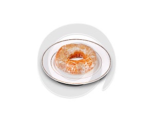 Sugary glazed donut on white plate