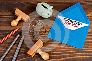 SUGGESTED FOR YOU. Letter on a wooden office desk