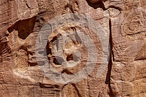 A suggestion of faces in the weathered patterns of a rock wall in the Grand Staircase-Escalante National Monument, Utah, USA