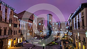 The suggestive medieval square Piazza del Popolo of Todi at sunset with christmas tree and decorations