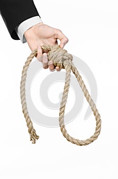 Suicide and business topic: Hand of a businessman in a black jacket holding a loop of rope for hanging on white isolated