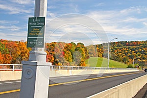 Suicide prevention phone sign on bridge in Fall