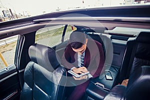 Suit man driving in a limo