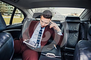 Suit man driving in limo car