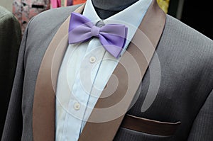 Suit with purple bow tie on headless mannequins