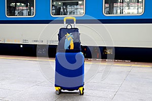 Suitcase and bag in colors of Ukraine flag at railway station, Prague, Czech Republic. Journey of Ukrainians, refugees, migrants.