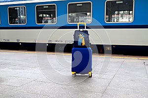 Suitcase and bag in colors of Ukraine flag at railway station, Prague, Czech Republic. Journey of Ukrainians, refugees, migrants.