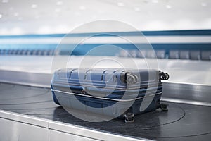 Suitcase on baggage claim in airport terminal