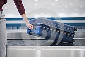 Suitcase on baggage claim in airport terminal