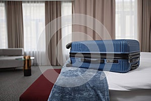 Suitcase on Bed in Luxury Hotel Room Interior