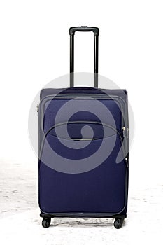 suitcase blue standing on white floor in front of white background