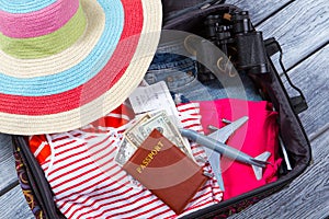 Suitcase with clothes and binoculars.