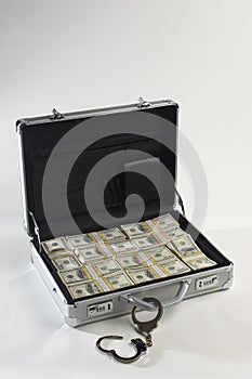 Suitcase And Dollars With Handcuffs