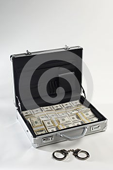 Suitcase And Dollars With Handcuffs