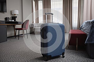 Suitcase on Floor  in Luxury Hotel Room Interior