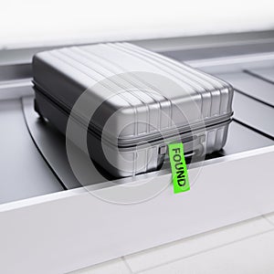 Suitcase with Green Found Sticker on Baggage Transporter 3d Illustration