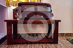 Suitcase lies on luggage stand in hotel