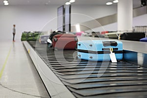 Suitcase or luggage on conveyor belt in the airport