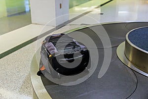 Suitcase or luggage with conveyor belt on baggage claim at the airport