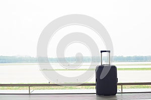 Suitcase near window in an airport