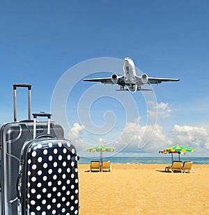 Suitcase and plane on the tropical island background