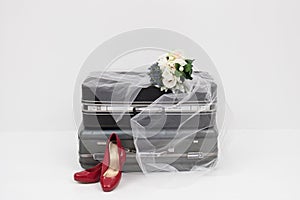 Suitcase with shoes, and flower ready for travel