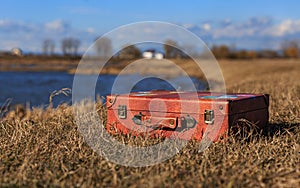 Suitcase on the shore of the hometown lake