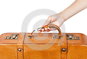 A suitcase with a torn handle. A woman& x27;s hand holds a torn-off handle of a suitcase.