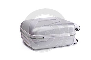 Suitcase white background. Silver plastic luggage or vacation baggage bag isolated. Copy space of summer vacation and business