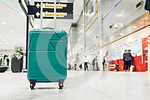 Suitcases in airport departure terminal with traveler people walking in background,Holiday vacation concept, Business