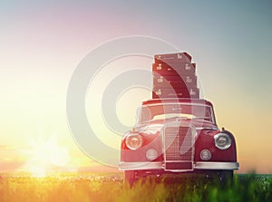 Suitcases are on roof of car.