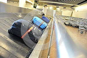 Suitcases on a transportation belt at the airport