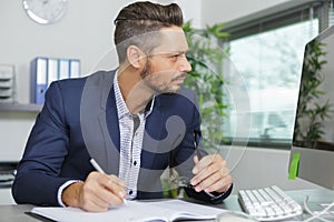 suited businessman working at desk