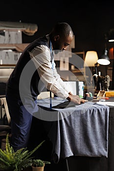 Suitmaker working on suit blazer photo