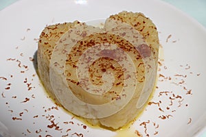 Suji Halwa or sheera, Indian sweet dish. Semolina dessert served in preety heart shape cake