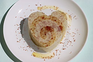 Suji Halwa or sheera, Indian sweet dish. Semolina dessert served in preety heart shape cake