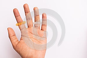 Sujok or acupressure therapy, applying pressure to the fingers with Sujok massager rings on  background