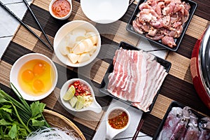 Sukiyaki . Preparation of raw materials,beef,egg ,tofu,vegetable and mung bean noodle  for sukiyaki using hot pots