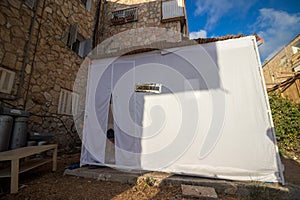 . A sukkah is covered with a white sheet in the