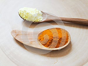 Sulfur powder and turmeric powder in a wooden spoon Helps nourish hair and skin.